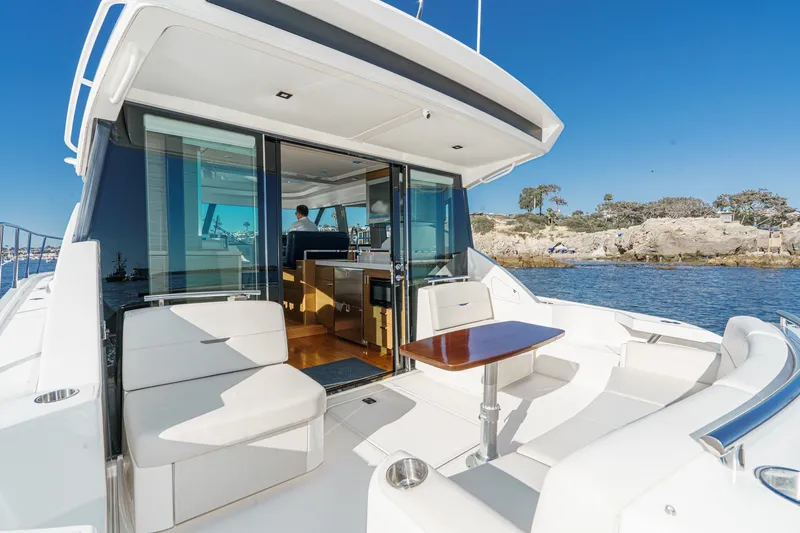 Slide: The Image of 2021 Tiara C 44 Coup yacht with luxurious seating and scenic ocean view. - 5