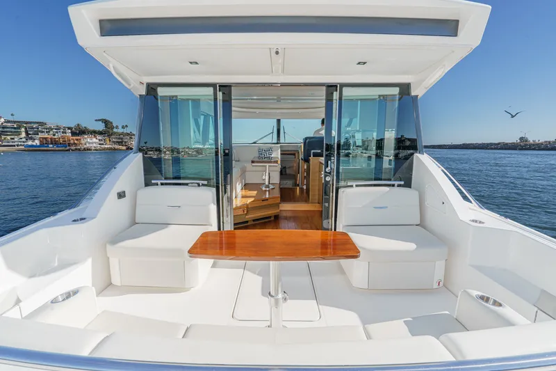 Slide: The Image of 2021 Tiara C 44 Coup yacht with elegant seating and ocean view. - 2