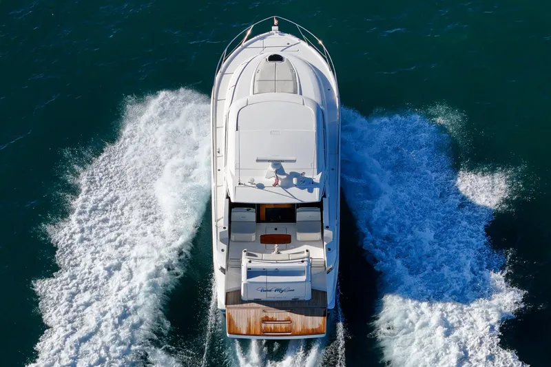 Slide: The Image of 2021 Tiara C 44 Coup yacht cruising on open water, aerial view. - 58
