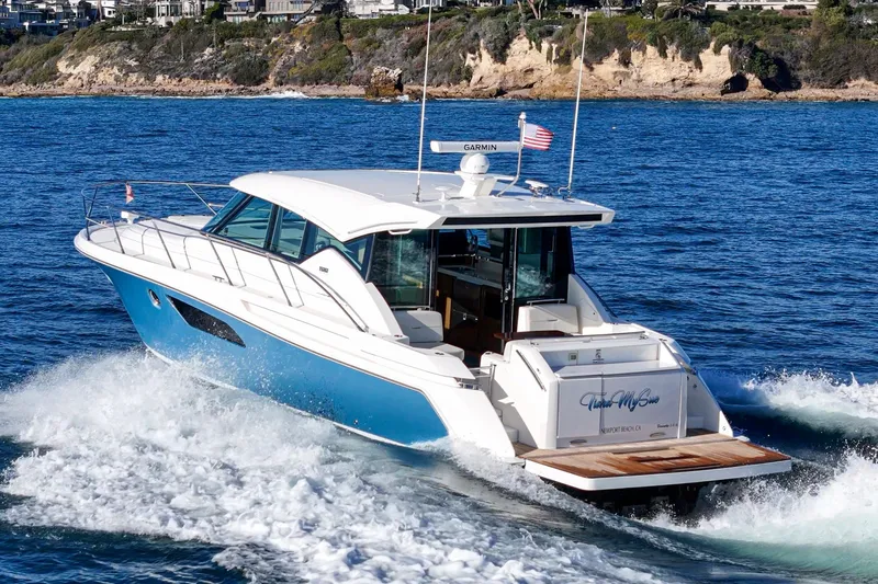 Slide: The Image of 2021 Tiara C 44 Coup yacht cruising on blue ocean waters. - 59