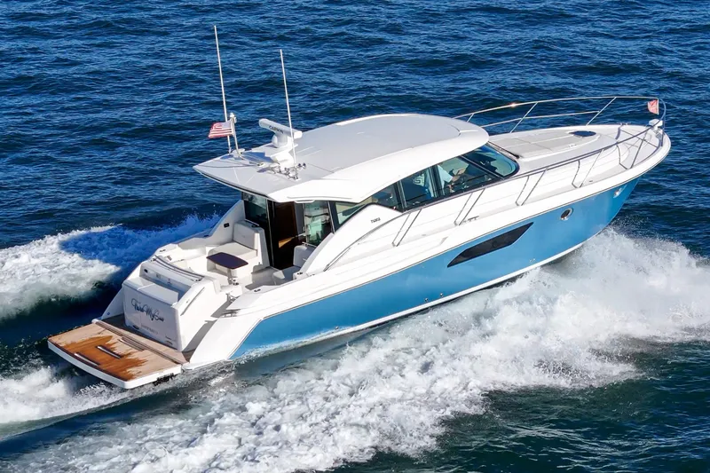 Slide: The Image of 2021 Tiara C 44 Coup yacht cruising on open water. - 55