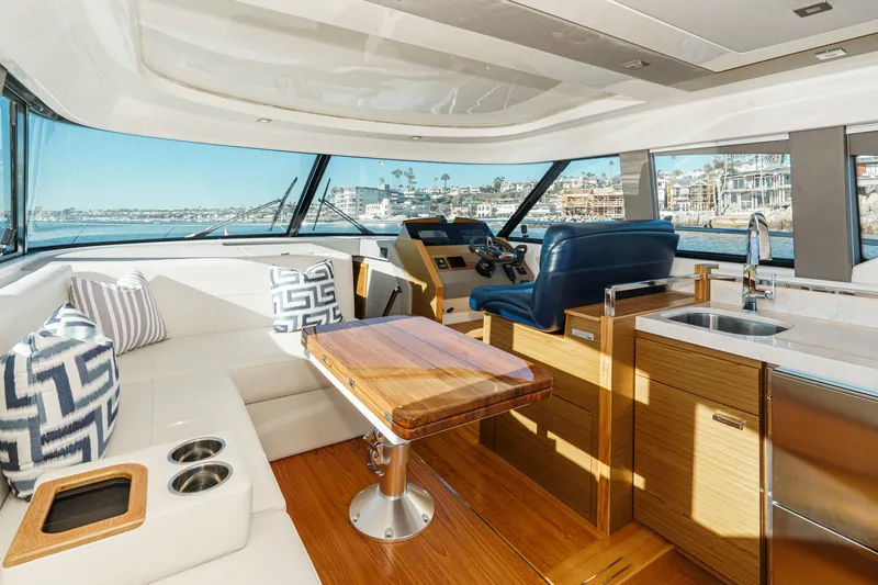 Slide: The Image of Luxurious interior of 2021 Tiara C 44 Coup yacht with modern seating and kitchen area. - 3