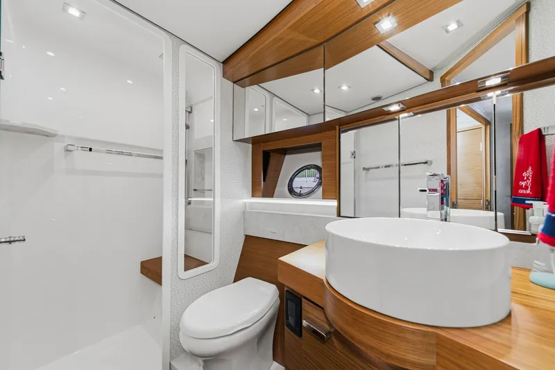 Slide: The Image of Luxurious bathroom in 2021 Tiara C 44 Coup yacht with modern fixtures and wood accents. - 36