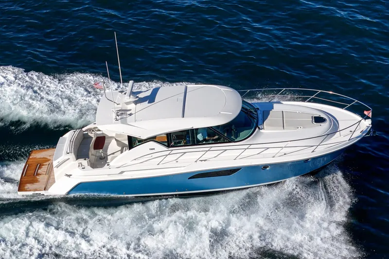 Slide: The Image of 2021 Tiara C 44 Coup yacht cruising on open water, side view. - 53
