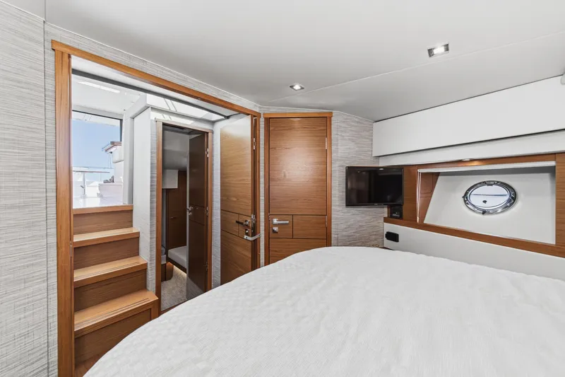 Slide: The Image of Interior of 2021 Tiara C 44 Coup yacht with modern wood finishes and porthole window. - 33