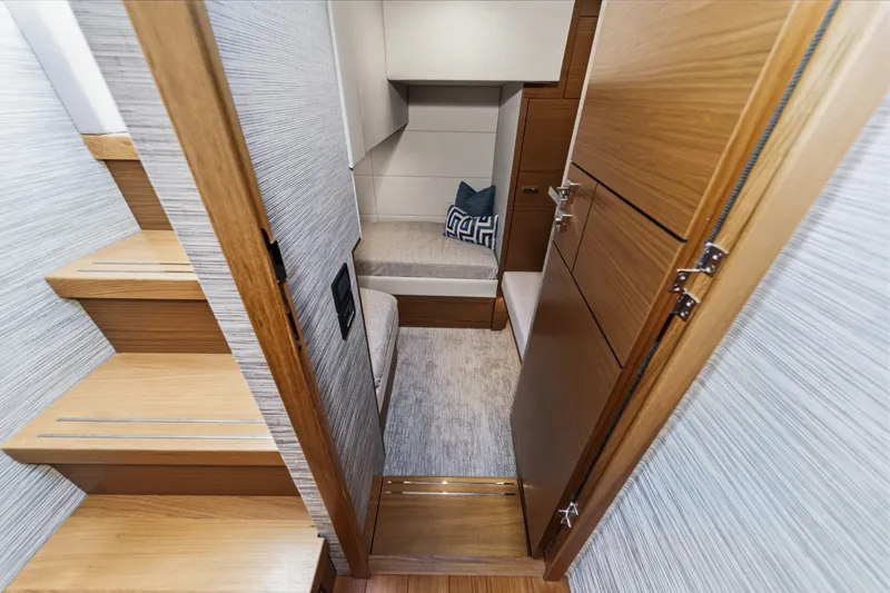 Slide: The Image of Interior of 2021 Tiara C 44 Coup yacht, featuring wooden stairs and cozy seating area. - 40