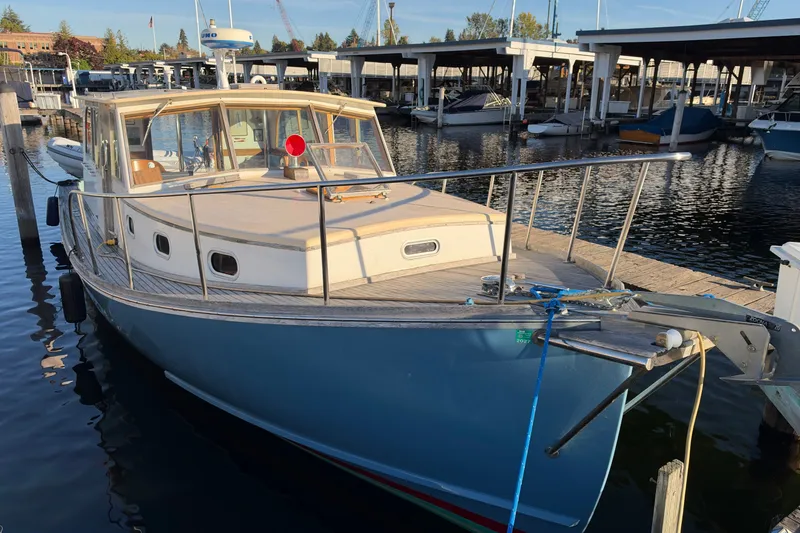 Slide: The Image of Covey Island Spencer Lincoln 1997 boat docked at marina, showcasing classic design and craftsmanship. - 24