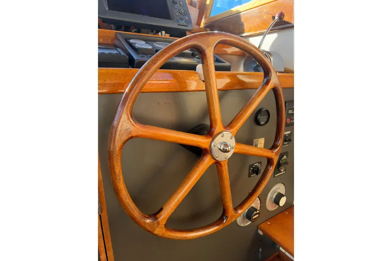 Slide: The Image of Wooden steering wheel on a 1997 Covey Island Spencer Lincoln boat. - 19