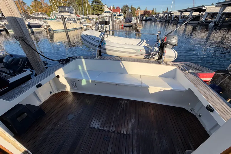 Slide: The Image of Spacious deck of a 1997 Covey Island Spencer Lincoln boat at a marina. - 36