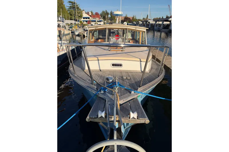 Slide: The Image of Covey Island Spencer Lincoln 1997 boat docked at marina, sunny day, clear water. - 25