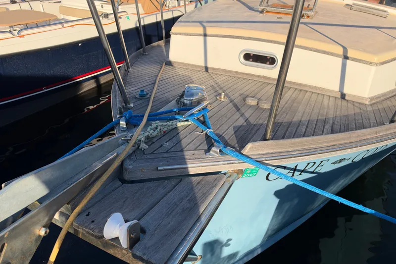 Slide: The Image of Bow of 1997 Covey Island Spencer Lincoln boat with ropes and deck details. - 26
