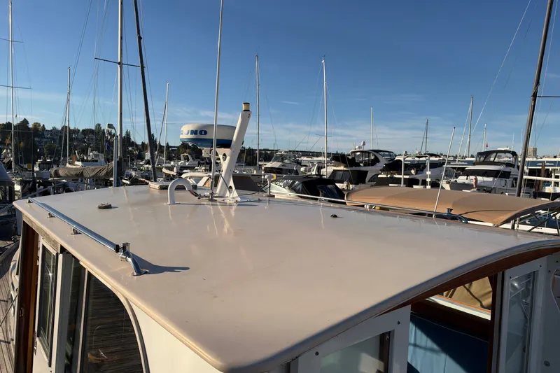 Slide: The Image of Covey Island Spencer Lincoln 1997 boat docked at marina under clear blue sky. - 33