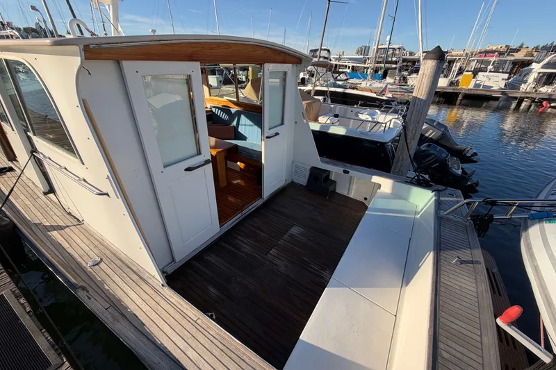 Slide: The Image of Covey Island Spencer Lincoln 1997 boat docked, featuring wooden deck and cabin interior. - 35
