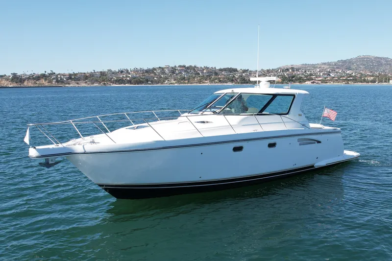 Slide: The Image of 2006 Tiara Yachts 3600 Sovran cruising on calm waters near a scenic coastline. - 7