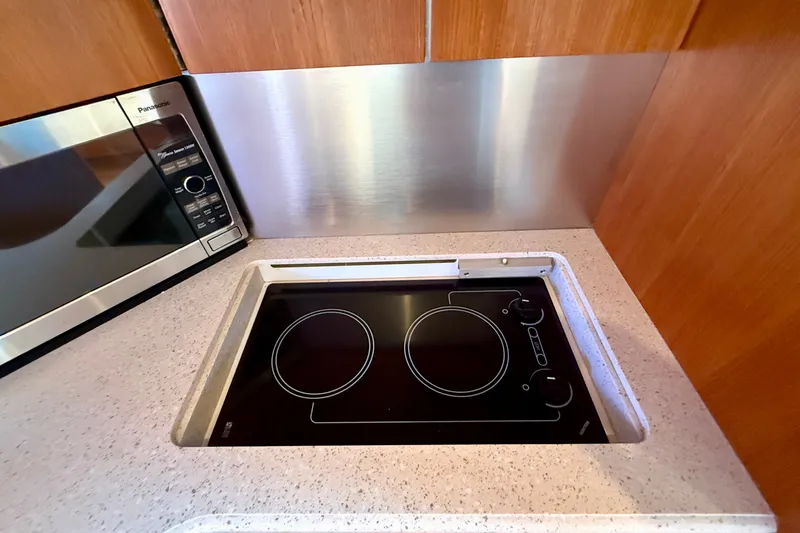 Slide: The Image of Modern kitchen area in a 2006 Tiara Yachts 3600 Sovran with stovetop and microwave. - 23