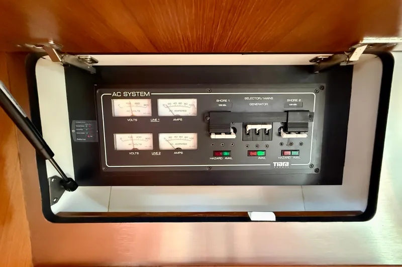 Slide: The Image of AC system panel on a 2006 Tiara Yachts 3600 Sovran, showing voltage and amperage gauges. - 18