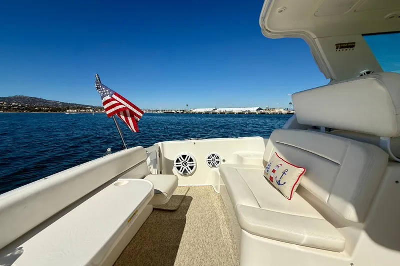 Slide: The Image of 2006 Tiara Yachts 3600 Sovran interior with American flag, ocean view, and nautical-themed pillow. - 46