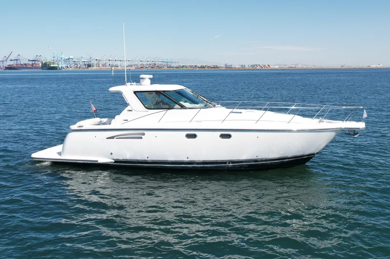 Slide: The Image of 2006 Tiara Yachts 3600 Sovran cruising on open water, port in background. - 8