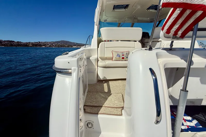 Slide: The Image of 2006 Tiara Yachts 3600 Sovran, elegant deck view with American flag, on serene waters. - 54