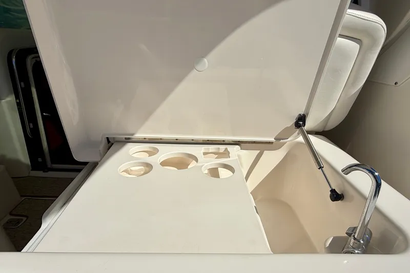 Slide: The Image of 2006 Tiara Yachts 3600 Sovran cockpit sink with cup holders and faucet. - 71