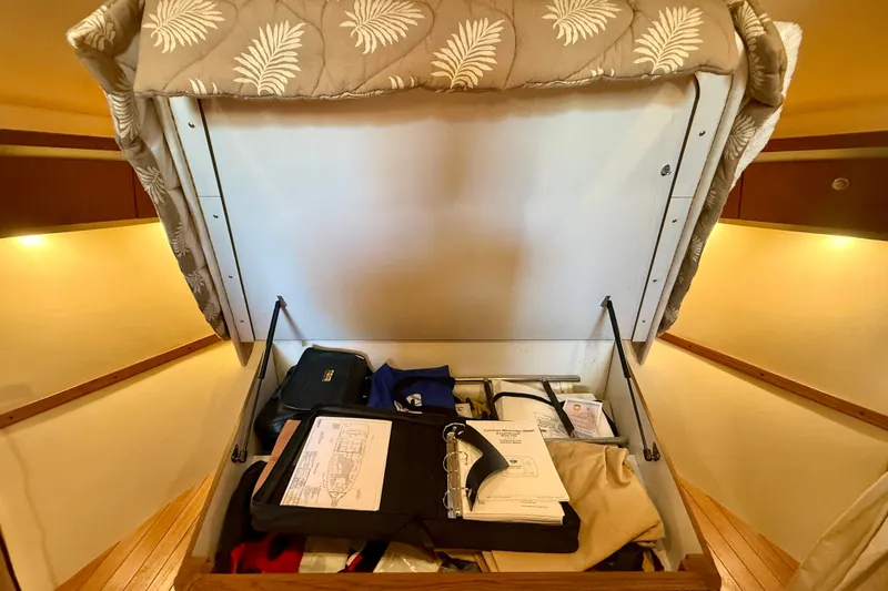 Slide: The Image of Storage compartment in a 2006 Tiara Yachts 3600 Sovran, containing documents and personal items. - 12