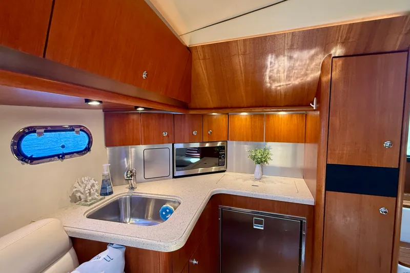 Slide: The Image of Luxurious 2006 Tiara Yachts 3600 Sovran galley with wood cabinetry and modern appliances. - 25