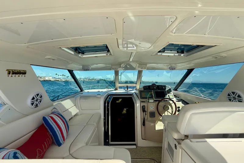 Slide: The Image of Interior of 2006 Tiara Yachts 3600 Sovran, featuring helm and seating with ocean view. - 44