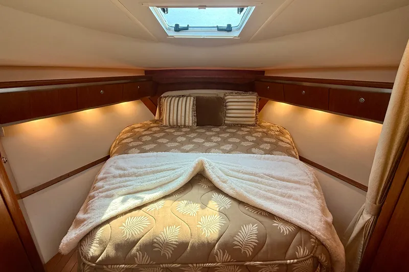 Slide: The Image of Luxurious cabin interior of 2006 Tiara Yachts 3600 Sovran with elegant bedding and ambient lighting. - 29