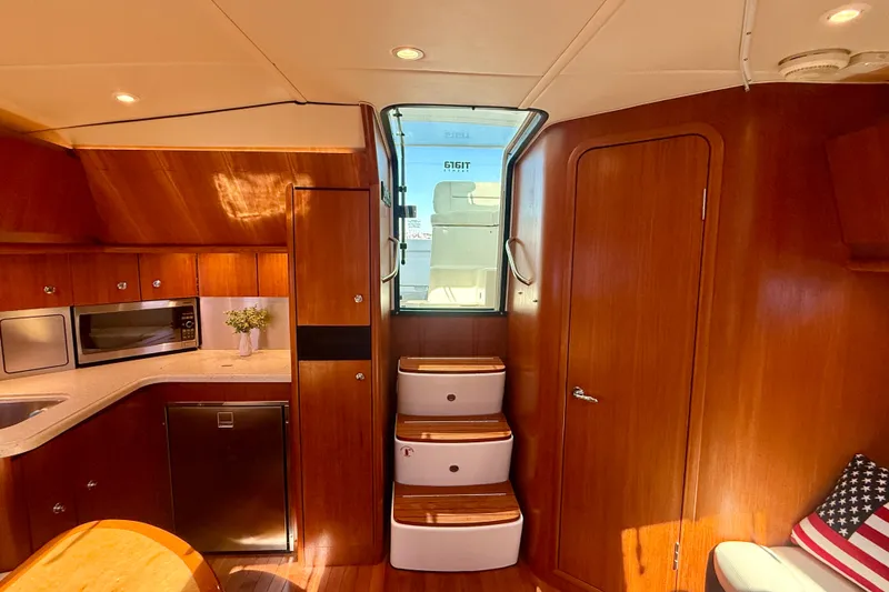 Slide: The Image of Interior of 2006 Tiara Yachts 3600 Sovran, featuring wood cabinetry and modern appliances. - 21