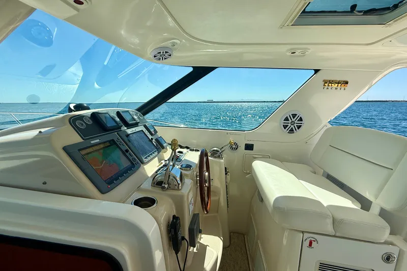 Slide: The Image of 2006 Tiara Yachts 3600 Sovran helm with navigation screens, overlooking the ocean. - 48