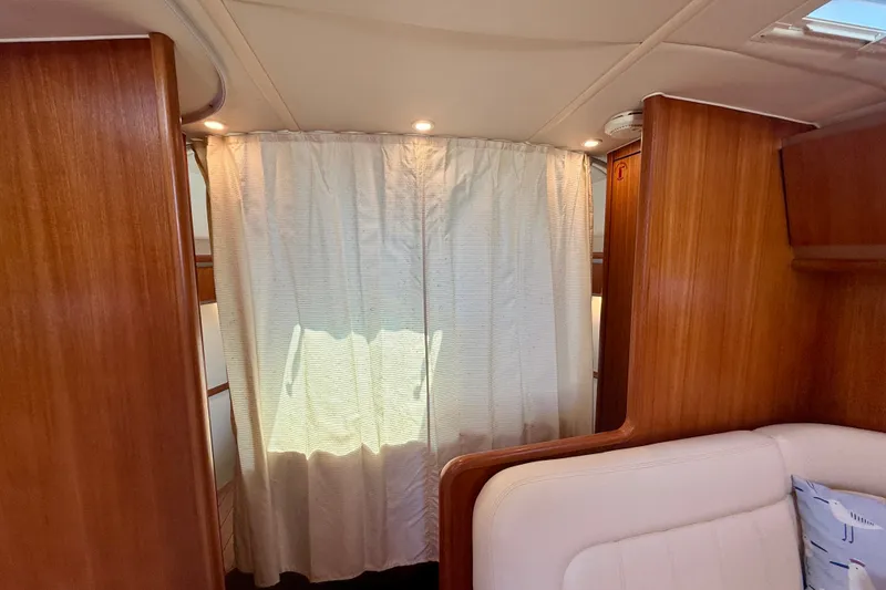 Slide: The Image of Interior of 2006 Tiara Yachts 3600 Sovran with wood paneling and curtain divider. - 33