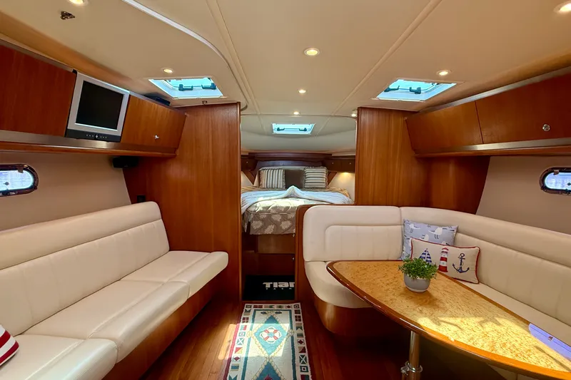 Slide: The Image of Luxurious interior of 2006 Tiara Yachts 3600 Sovran with elegant seating and cozy sleeping area. - 13