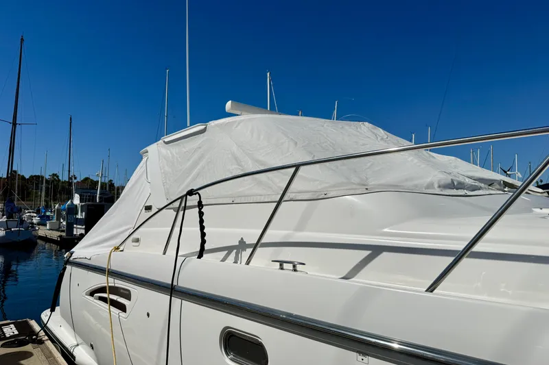 Slide: The Image of 2006 Tiara Yachts 3600 Sovran docked, covered with tarp, under clear blue sky. - 73