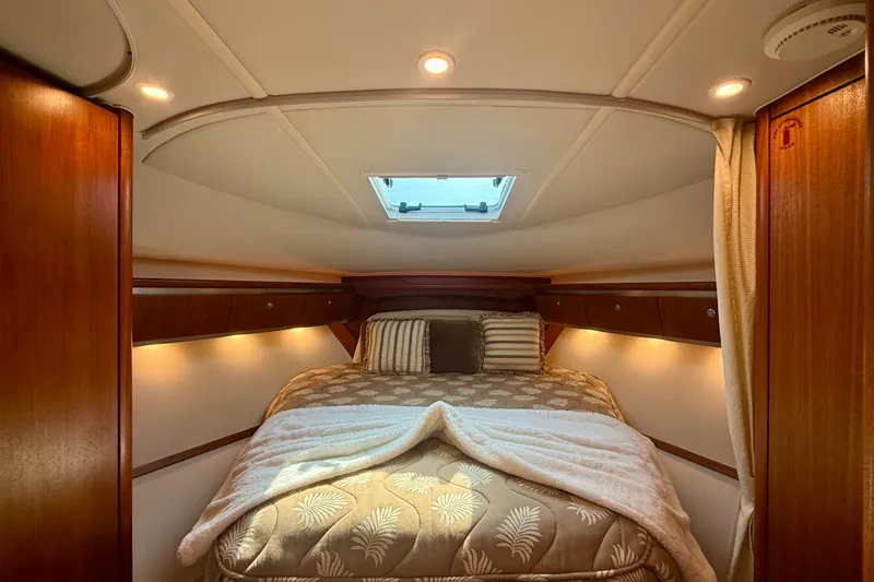 Slide: The Image of Luxurious cabin interior of 2006 Tiara Yachts 3600 Sovran with cozy bedding and ambient lighting. - 28