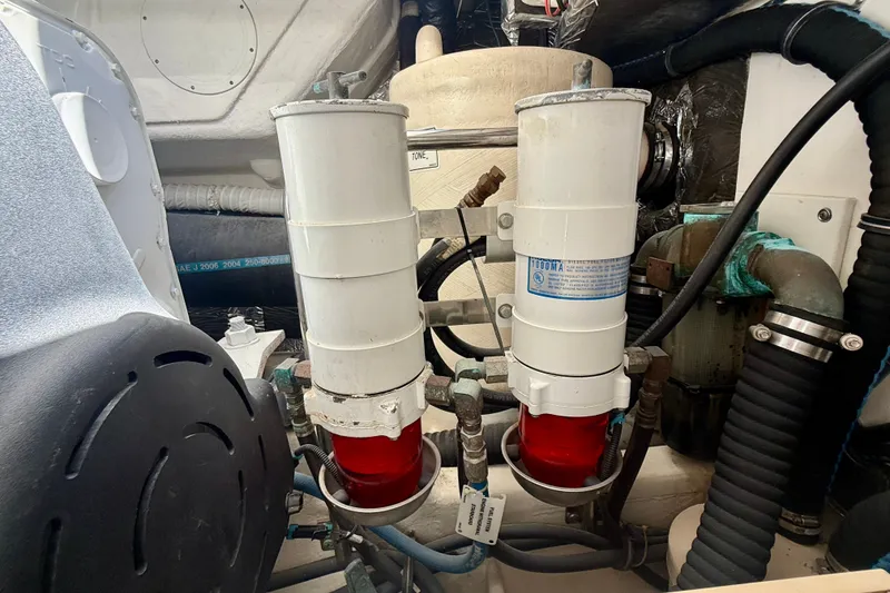 Slide: The Image of Engine room of 2006 Tiara Yachts 3600 Sovran, featuring dual fuel filters. - 68