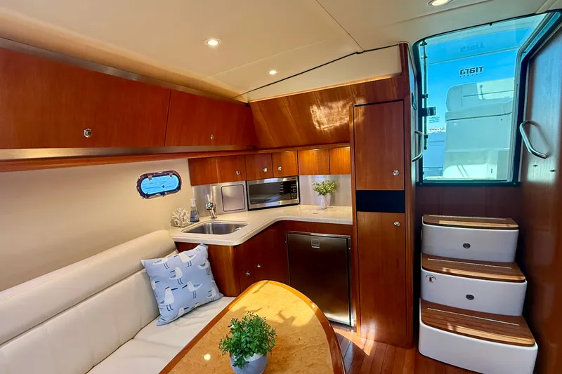 Slide: The Image of Luxurious interior of 2006 Tiara Yachts 3600 Sovran with modern kitchen and cozy seating area. - 22