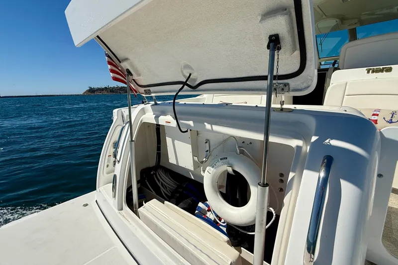 Slide: The Image of 2006 Tiara Yachts 3600 Sovran with open storage compartment, life ring, and American flag. - 52