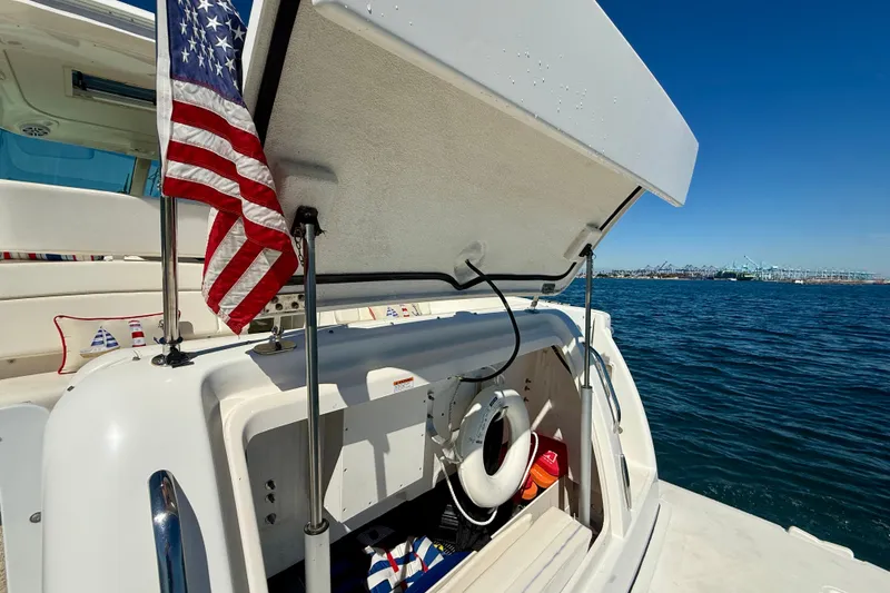 Slide: The Image of 2006 Tiara Yachts 3600 Sovran with open storage, American flag, and ocean view. - 51