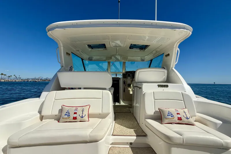 Slide: The Image of 2006 Tiara Yachts 3600 Sovran interior with plush seating and nautical-themed pillows. - 45