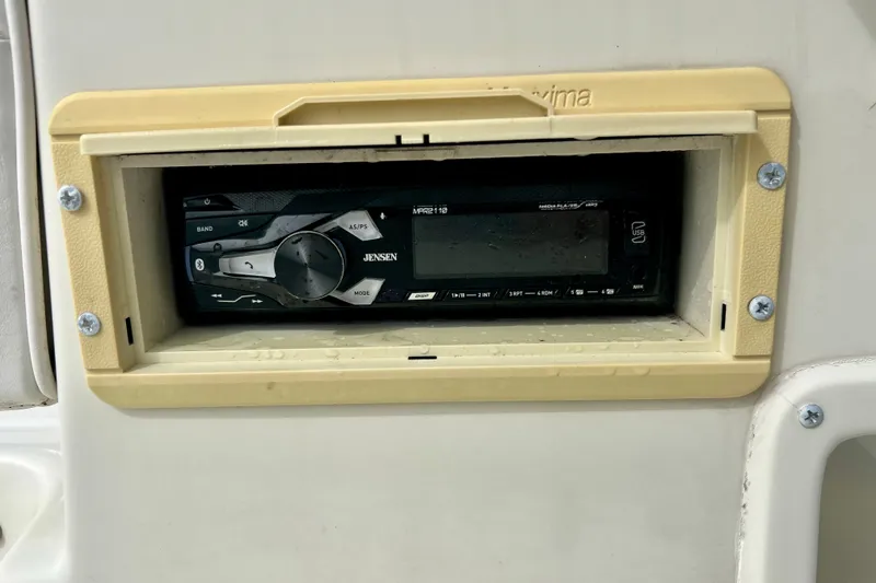 Slide: The Image of Built-in Jensen stereo system on a 1995 Wahoo 1650 boat dashboard. - 31