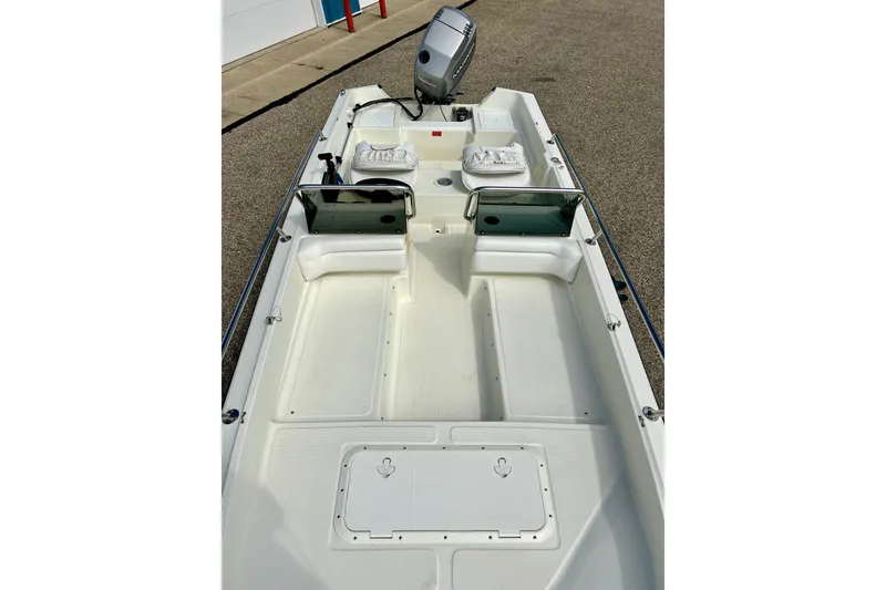 Slide: The Image of 1995 Wahoo 1650 boat interior with seating and storage compartments. - 34