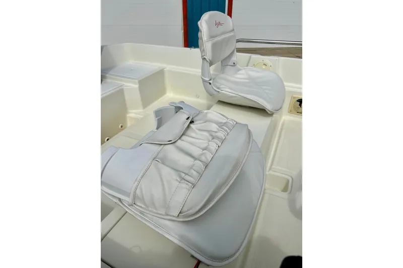 Slide: The Image of White seating on a 1995 Wahoo 1650 boat, showcasing clean upholstery and design. - 19