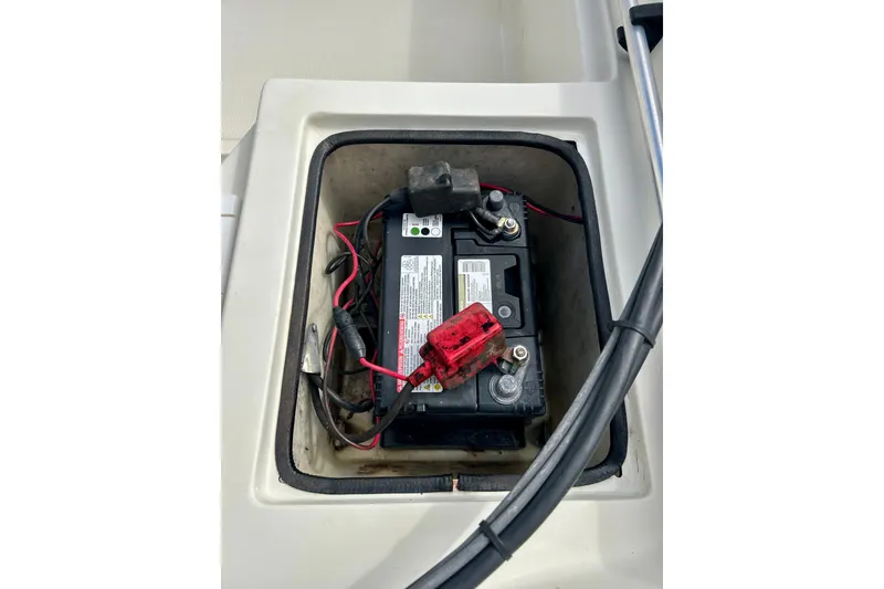 Slide: The Image of Battery compartment of a 1995 Wahoo 1650 boat, featuring wiring and connections. - 14