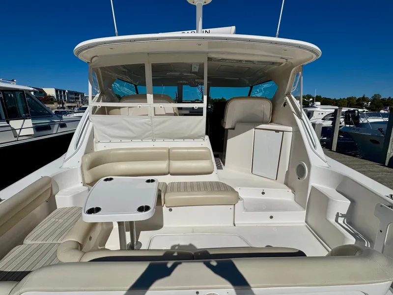 Slide: The Image of 2006 Tiara Yachts 4300 Sovran with spacious cockpit, comfortable seating, and table, perfect for relaxing. - 18