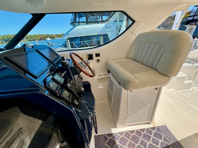 Slide: The Image of The cockpit of the 2006 Tiara Yachts 4300 Sovran features a sleek helm and comfortable seating. - 26