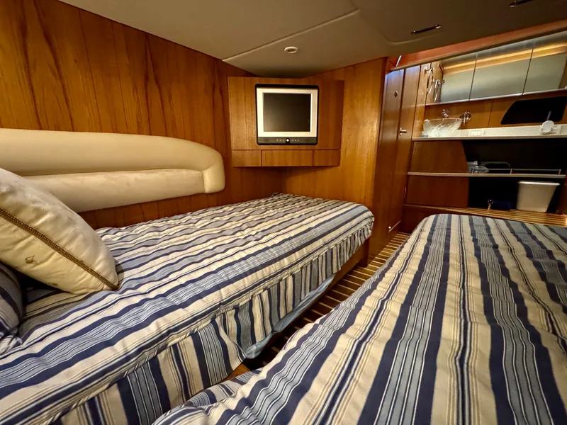 Slide: The Image of Cabin with two single beds and a wall-mounted TV. - 46