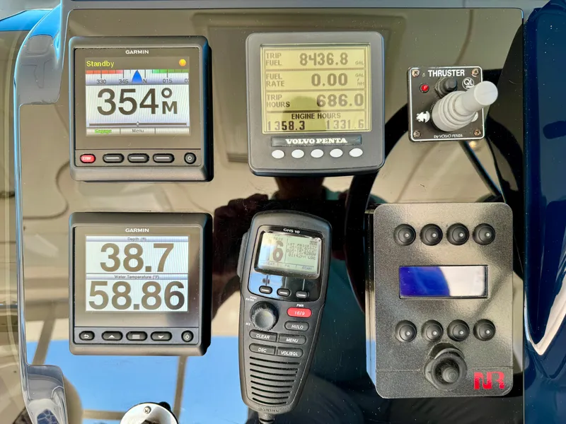 Slide: The Image of The image shows the dashboard of a 2006 Tiara Yachts 4300 Sovran with various instruments. - 30
