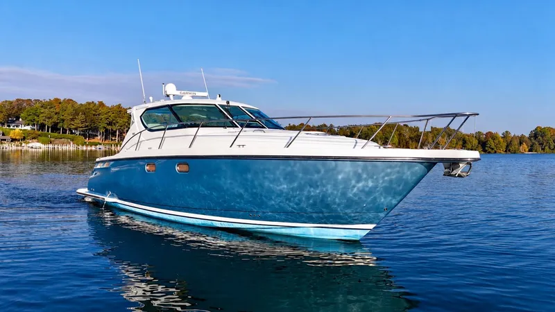 The Image of A 2006 Tiara Yachts 4300 Sovran on calm water, featuring a blue hull and white deck. - 0
