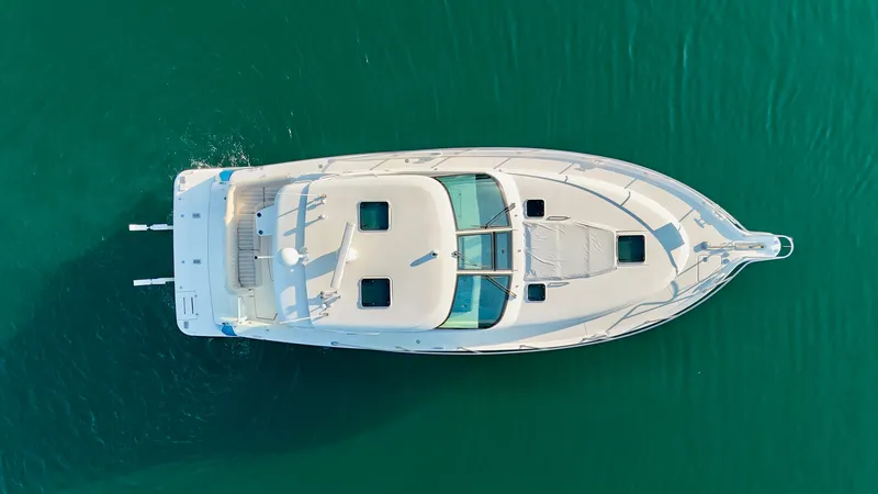 Slide: The Image of Aerial view of a 2006 Tiara Yachts 4300 Sovran on calm water. - 13