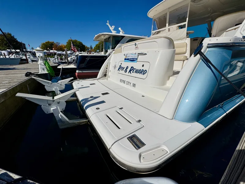 Slide: The Image of A 2006 Tiara Yachts 4300 Sovran docked. It features a sleek design and spacious platform. - 17